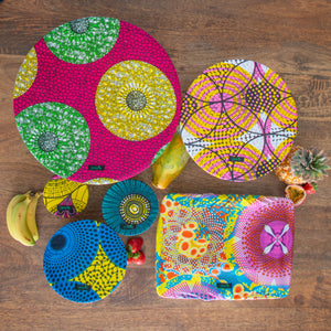 A set of six food covers in bright African Island colours.
